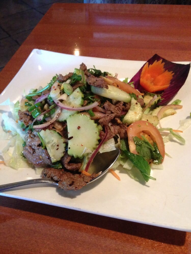 Shrimp pad thai noodles topped with fresh herbs and lime wedge